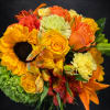 Bright flowers arranged in a lower vase. Perfect for an office or