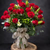 Two dozen roses arranged intricately with stock, filler and greenery.