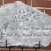 Gray stone memorial plaque with carved birds, a feather, and the inscription 'Your Wings Were Ready, But My Heart Was Not.'