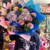 This beautiful bouquet not only contains hydrangeas and roses but also lights