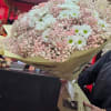A jumbo bouquet made up of pink baby breath and daisy's. A