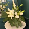 A spare, modern silhouette of white calla lilies and tall Bells of