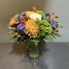 A garden mix of flowers.

Measures approx. 17" tall x 15" diameter and