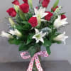 Choose this mixture of red roses and white oriental lilies to put