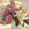 An elegant blend of soft lavender roses, fragrant pink lilies, white freesia