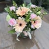 Bouquet of peach gerbera daisies and pink carnations in a glass vase
