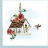 Greeting card with quilled paper birdhouse, two small birds, and decorative spiral flowers.