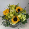 A beautiful combination of golden sunflowers, mini green hydrangeas, and exotic cymbidium