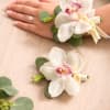 A beautifully coordinated set featuring an elegant orchid wrist corsage and a