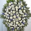 A graceful and elegant blue and white standing sympathy spray designed to