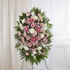 A stunning and elegant standing spray featuring a soft and romantic pink