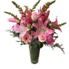 Pink lilies, roses, and snapdragons arranged in a tall glass vase