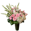 Tall pink and white flower arrangement with gerbera daisies and hydrangeas in a green-wrapped vase