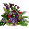Basket arrangement with purple hydrangeas, red roses, tall purple flowers and lush ferns.