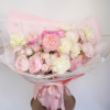 Round bouquet of pale pink and cream roses and peonies in a pink hatbox with ribbon