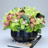 This beautifully textured ceramic vase arrangement is overflowing with fresh Cymbidium Orchids