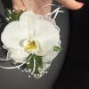 White orchids paired with pearl or rhinestone accents for a refined, upscale