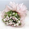 The bouquet shown is 4 bunches of tulips paired with seasonal greenery.