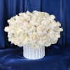 An elegant array of reflexed white Roses on top of white Hydrangea