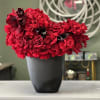 This unique, stylish arrangement comprises reflexed red Roses and black Calla Lilies