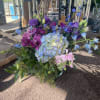 Square cube leaf lined and filled with blue hydrangea, lavender stock, blue