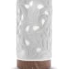 White carved diffuser with glowing cutout pattern and wood-look base