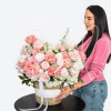 Large pink and white rose arrangement in a woven basket