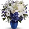 A beautiful and elegant floral arrangement designed in a blue vase featuring