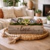 Succulent arrangement in a rustic wooden box with the word love