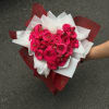 A dense cluster of vivid pink roses arranged into a Hand Wrapped
