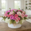 Pink and white rose arrangement in a white hat box