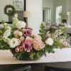 Low floral centerpiece with pink and white blooms in a black bowl vase