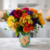 Colorful bouquet of roses and sunflowers in a glass vase