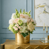 Cream and blush rose arrangement in a gold vase