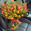 Bouquet of pink and yellow tulips with yellow filler flowers