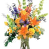 Orange and yellow mixed bouquet in a clear glass vase