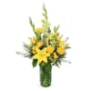 Sunlit yellow lilies and clustered yellow roses give this sympathy-style flower arrangement