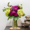 Magenta and lime hydrangea bouquet in a clear glass vase