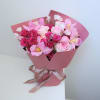 Pink bouquet of roses and tulips wrapped in pink paper