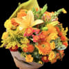 Bouquet of orange, yellow, and pink flowers wrapped in paper