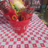 Coca-Cola cans and candy in a pink heart-patterned bucket
