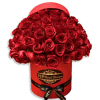 Red roses arranged in a red hatbox with a ribbon