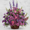 Basket arrangement of pink and purple flowers with tall lavender spikes
