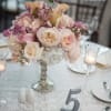 Silver pedestal with premium roses, mini callas and orchids.
