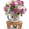 A playful and heartwarming floral arrangement designed in a collectible Snoopy keepsake