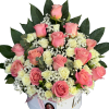 A lush cluster of pink and ivory roses arranged inside a white