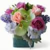 Calming lavender roses, soothing mint accents, and elegant orchids come together in