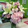 Pink and white floral arrangement in a glass vase