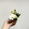 White and gold pin on boutonniere. For specific flowers, please comment in