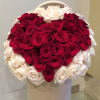 Heart-shaped bouquet of red and white roses in a white box